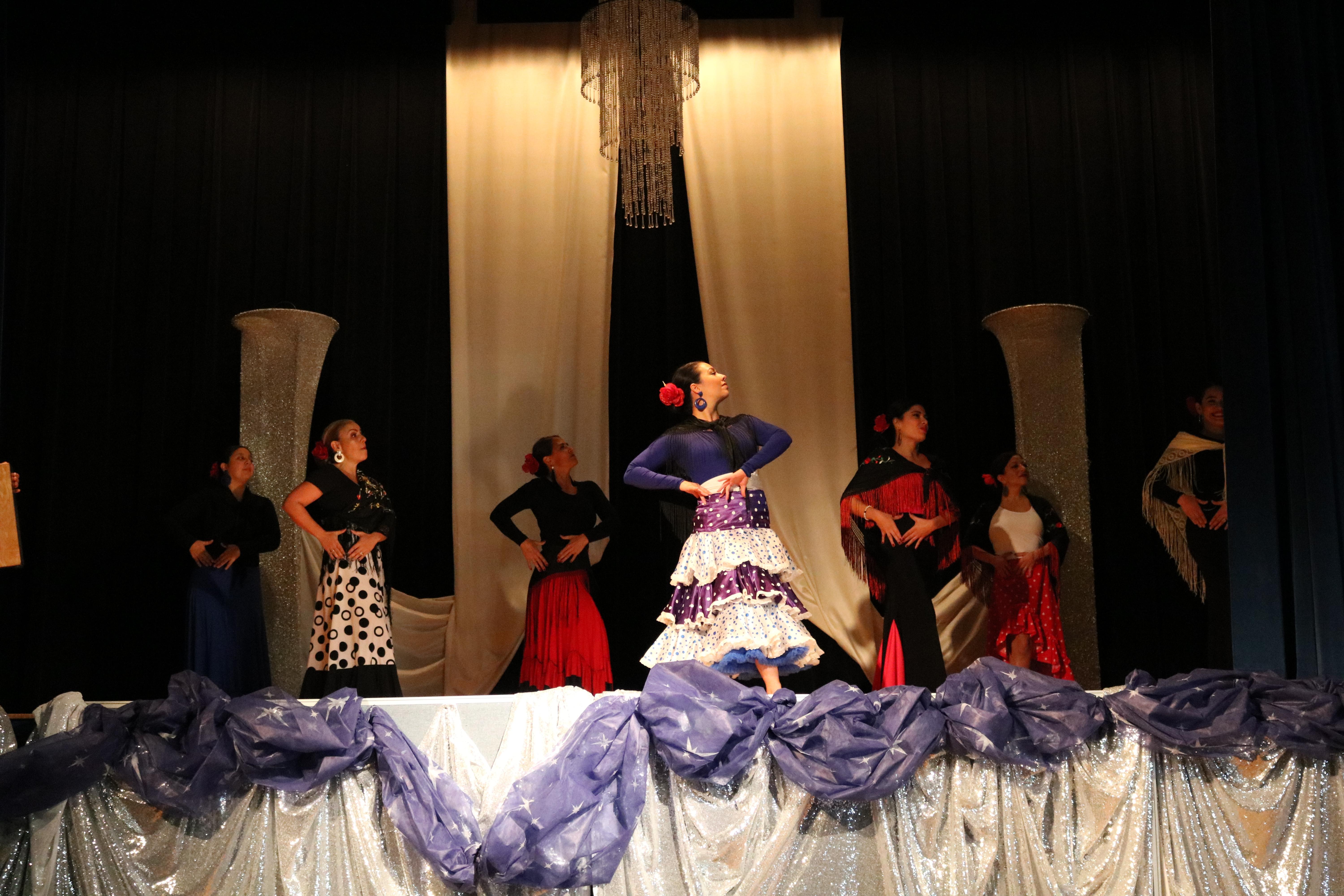 six female teachers of  CP dressed in flamenco costumes and dancing to traditional spanish music