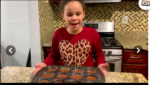 girl showing off cupcake pan
