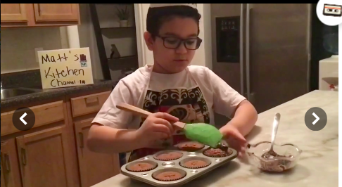 boy putting frosting on cupcake